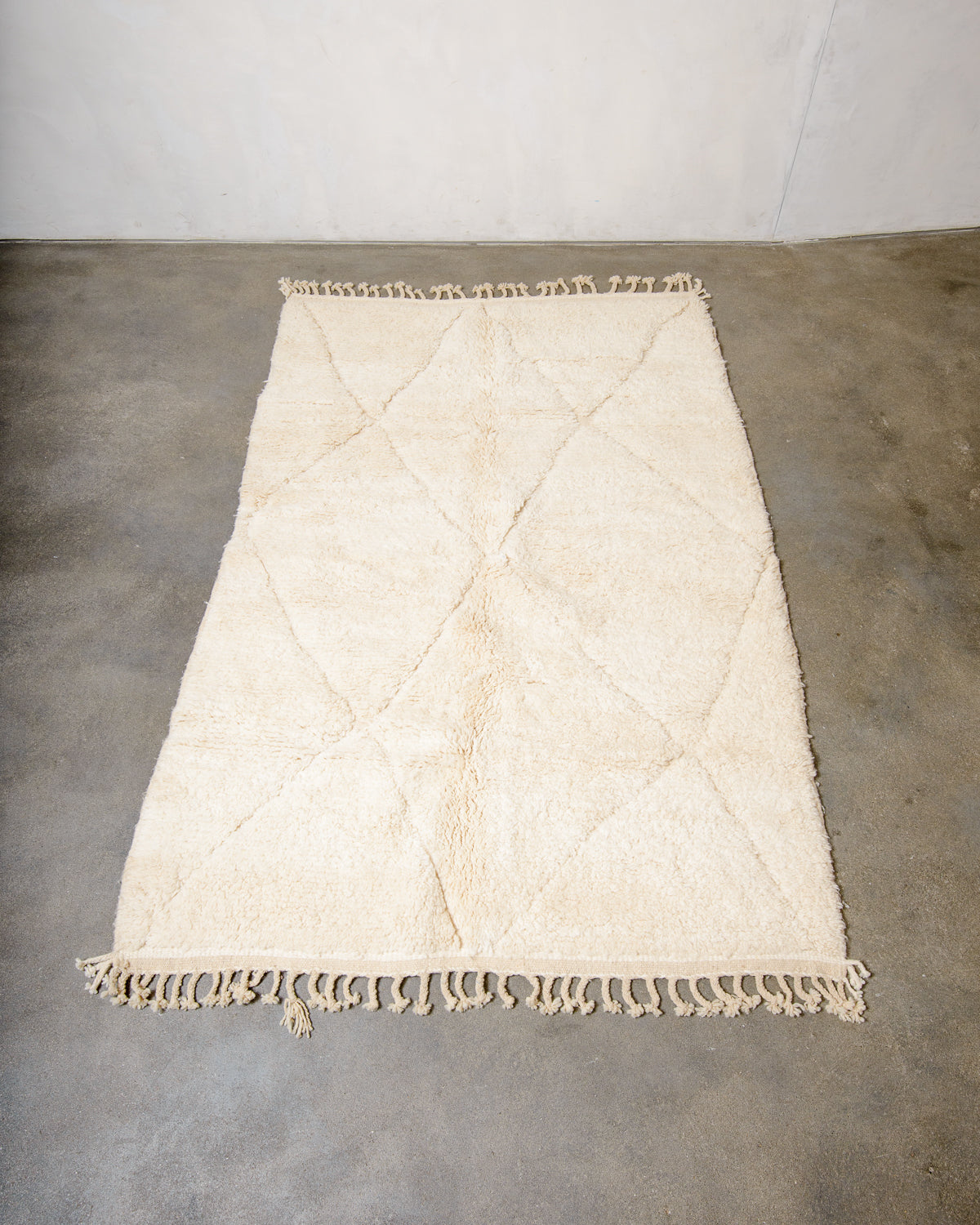 Modern, designer, handcrafted Berber rug from Morocco. Beniourain carpet with minimalist design, natural wool pile and a fluffy texture.